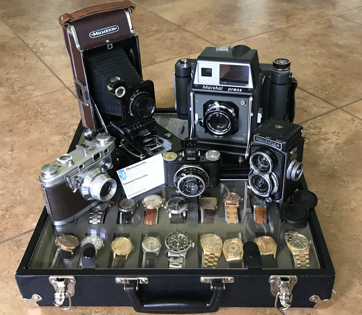 Collection of vintage film cameras and watches in a case - we buy cameras, lenses and watches